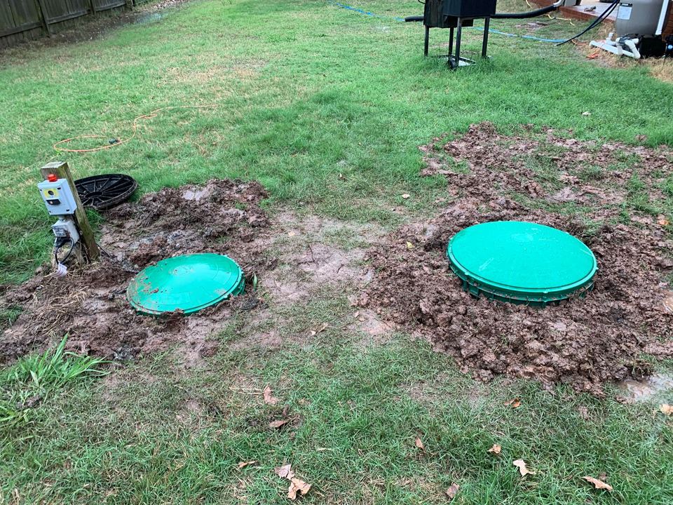 Septic tank access lids and control panel in a Central Arkansas yard